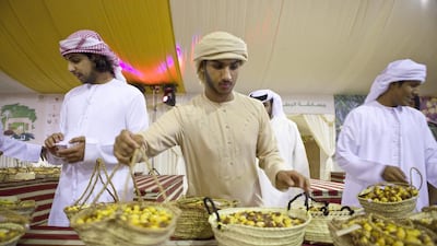 Competitors last year preparing for opening night at the Liwa Date Festival, the 10th edition of which opens on July 12, 2014. Razan Alzayani / The National