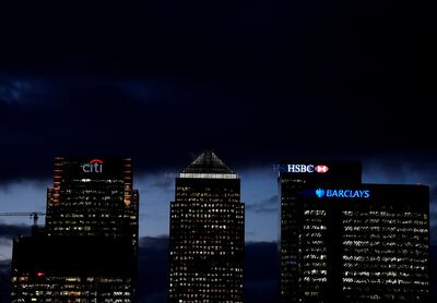 The Barclays office is lit up at dusk alongside the buildings of other major players in the international banking world, at Canary Wharf, London. Reuters