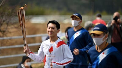 Ryo Matsumoto, a student of Nippon Sport Science University, carries the Olympic torch. AFP