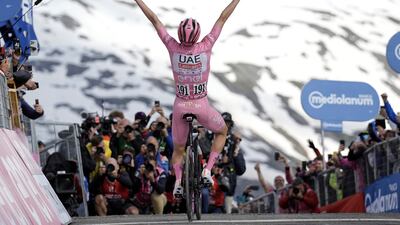 Tadej Pogacar celebrates after winning Stage 15. AP