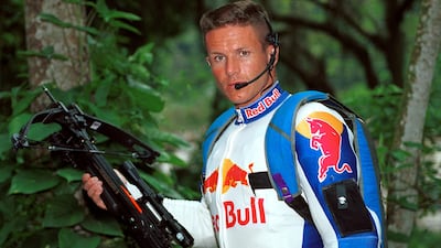 Mr Baumgartner poses with the crossbow he used to scale the arm of the Christ the Redeemer statue atop Corcovado mountain, and parachute off, in Rio de Janeiro. Reuters