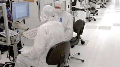 Engineers work at a Globalfoundries laboratory in Dresden, Germany. Mubadala intends to invest significantly in the company.