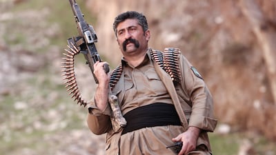 ERBIL, IRAQ - MARCH 12: A member of Komala of the Toilers of Kurdistan, a Kurdish Iranian dissident group, guards against drone attack near their military bases hidden among the mountains on March 12, 2026 in Khalifa, Erbil Province, Iraq. The group is part of the Coalition of Political Forces of Iranian Kurdistan, an alliance of major Iranian Kurdish parties headquartered in Iraq. While all eyes are on the continuing US and Israeli strikes against Iran, another potential battlefront is brewing on the border with Iraq. Kurdish militia fighters are preparing for war with the hope of liberating their fellow Kurds in western Iran. (Photo by Sedat Suna / Getty Images)