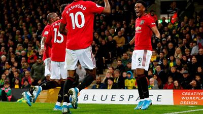 Manchester United's Anthony Martial, right, celebrates with teammates after scoring their third goal during against Norwich City at Carrow Road. AFP