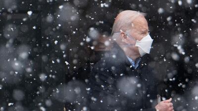 US President Joe Biden makes his way to his vehicle in the snow, after attending Mass at Saint Joseph on the Brandywine Church in Wilmington, Delaware. AFP