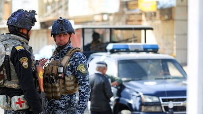 Iraqi federal police forces stand guard at a checkpoint in a street in the capital Baghdad. AFP Photo