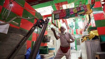 Khaleel, who uses one name, is one of the last remaining traditional water carriers in India, known as mashakwala. He draws water from a well at a Delhi shrine, fills it into containers known as mashaks, and then sells it to nearby eateries and shops. On Fridays, he offers water to devotees for free. All Photos: Taniya Dutta / The National