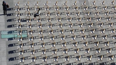 A woman takes a photo in front of a statue and empty chairs symbolising victims of comfort women in Seoul, South Korea. South Korea announced on Wednesday a review of the 2015 agreement between South Korea and Japan over South Korea's comfort women issue. Lee Jin-man / AP