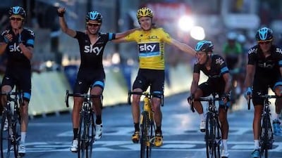 Chris Froome, centre, of Great Britain celebrates in Paris after winning the Tour de France on Sunday. Doug Pensinger / Getty Images