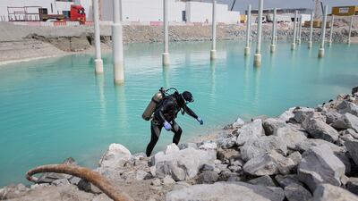 Diver Neerag Kumar, 27, works on installing marine piles around Louvre Abu Dhabi in March 2015. Silvia Razgova / The National