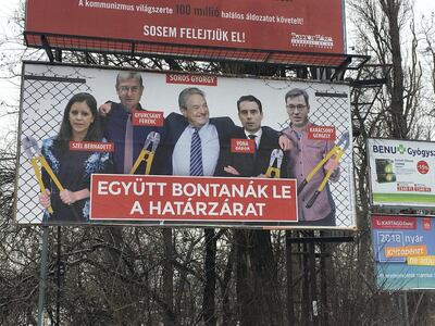Election posters by Hungary's ruling party Fidesz party labelled George Soros, centre, and its political rivals as opponents of the government's asylum policies. Paul Peachey / The National