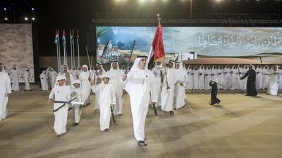 Lt General Sheikh Saif bin Zayed Al Nahyan, Deputy Prime Minister and Minister of Interior, centre, dances during the National Day celebrations. Rashed Al Mansouri / Crown Prince Court - Abu Dhabi
