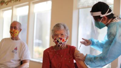 Joyce Flippin, 83, receives a dose of the coronavirus vaccine at Mission Commons assisted-living community in Redlands, California, US. Reuters