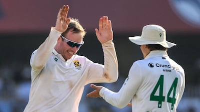 South Africa's Simon Harmer celebrates with teammate Ryan Rickelton after taking the wicket of India's Washington Sundar. AFP