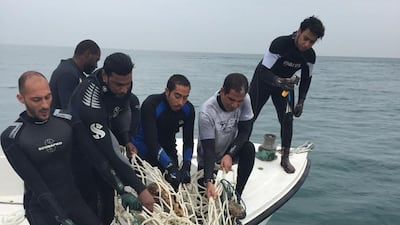 Divers help remove waste from a shipwreck that sank 56 years ago in Sharjah. Courtesy Sharjah Museums Department