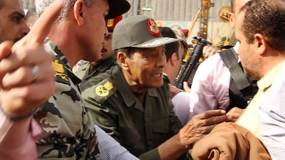Mohammed Hussein Tantawi talks to anti-government protesters in Tahrir Square, Cairo, during the 2011 uprising against Hosni Mubarak, Egypt's president at the time. AFP