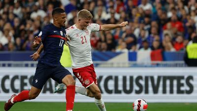 Denmark's Andreas Cornelius, right, scores his side's second goal. AP