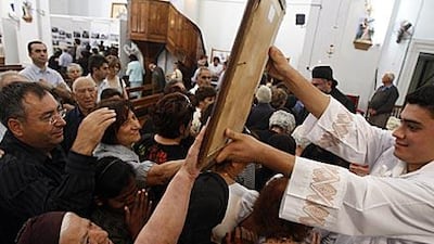 Cypriot Maronites touch an icon at Saint George's Church in Kormakitis, Cyprus. The Aramaic language of the earliest Christians lives on in the church services of the village.