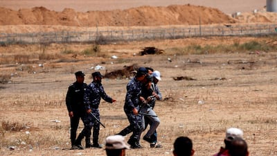 Palestinian Hamas police block protesters from reaching the border fence east of Khan Yunis in the southern Gaza Strip. AFP
