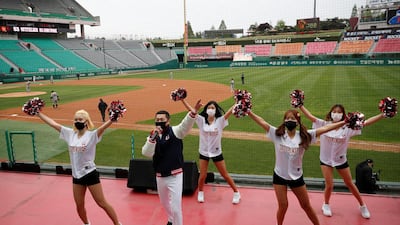 A cheering group in South Korea wave pompoms to an empty stadium as sports leagues starts behind closed doors. Reuters