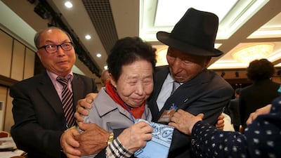 South Korean Lee Jin-goo, centre, meets her North Korean brother Lee Yong Goo, right, during the separated family reunions at Mount Kumgang resort. Reuters