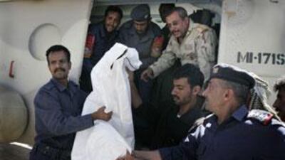 Yemeni soldiers and health workers carry one of three retrieved bodies of the kidnapped foreigners off a military helicopter in San'a, Yemen, on June 16 2009.