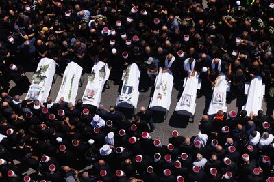 Mourners at the coffin during a funeral for people killed in a rocket strike from Lebanon a day earlier, in the occupied Golan Heights. Bloomberg