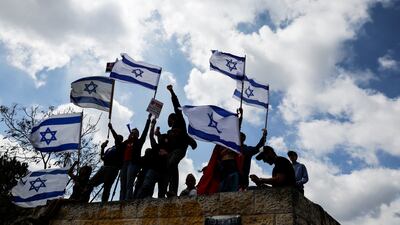 Protesters hold flags aloft in Jerusalem. Reuters