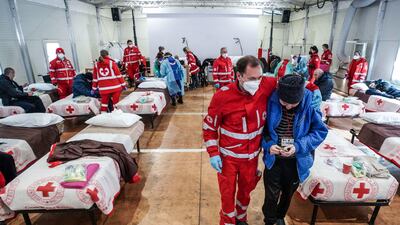 Ukrainian refugees, who arrived in Italy from Lviv after two weeks of travel, are tended to in the reception centre of the Red Cross in Settimo Torinese, near Turin. EPA