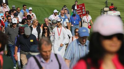 An Emirati and fans of different nationalities attend the first round of the Abu Dhabi HSBC Golf Championship. Now in its 10th year, the event has become a firm fixture on the calendars of golfers the world over. Kamran Jebreili / AP