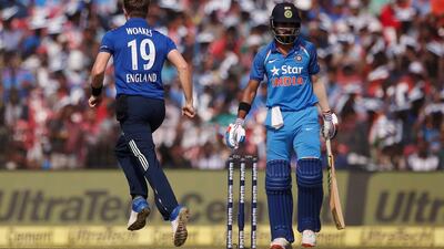 England medium pacer Chris Woakes, left, celebrates the dismissal of India opening batsman Lokesh Rahul. Adnan Abidi / Reuters