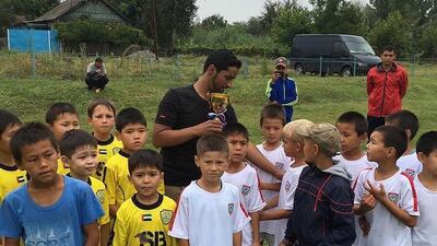 Salem Alkarbi hosts events for disadvantaged children worldwide through his football charity "Beyond the Boundaries of Football". Here he is in Kirghistan. Courtesy Salem Alkarbi