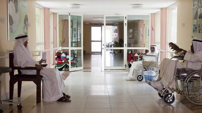 Patients relax in the hallway of the Ajman Elderly Care Home. Razan Alzayani / The National
