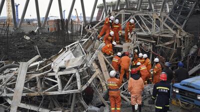 Rescue workers look for survivors after a work platform collapsed at the Fengcheng power plant in eastern China's Jiangxi Province. Wan Xiang / Xinhua via AP