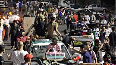 Rebel fighters celebrate the downfall of Muammar Qaddafi in 2011. EPA