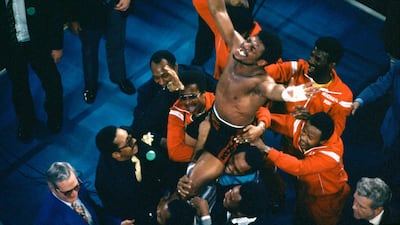 Leon Spinks celebrates as his entourage holds him aloft after his 15-round split decision victory over world heavyweight boxing champion Muhammad Ali in Las Vegas on February 15, 1978. AP