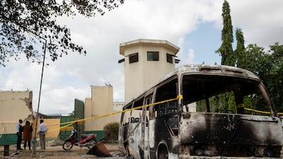 A burnt-out vehicle at the entrance to the prison after the attack by gunmen in Kuje. Reuters