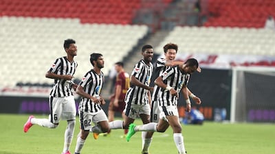Al Jazira players celebrate after Yaser Matar scores late on to seal victory over Al Wahda. Delores Johnson / The National