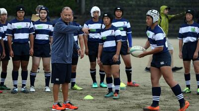 England head coach Eddie Jones with students at Tsurumigaoka High School in Beppu on Thursday . Getty
