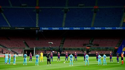 Barcelona and Leganes players hold a minute of silence prior to the match. AP Photo
