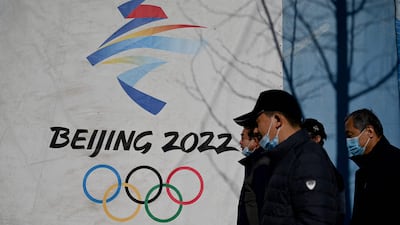 People walk past the Beijing 2022 Winter Olympics logo at the Shougang Park in Beijing. AFP