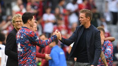 Bayern Munich's Robert Lewandowski shakes hands with coach Julian Nagelsmann after the match. Reuters