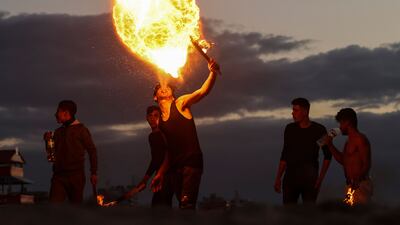 Palestinian youth show their fire breathing skills in Gaza city. AFP