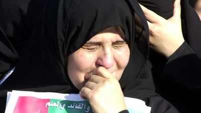 Mourners carry photos of Sheikh Zayed while standing in the streets on the day of the UAE Founding father's funeral