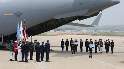 UN honor guards carry the boxes containing remains of American servicemen. Getty Images