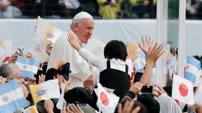 Pope Francis waves to well-wishers as he enters the venue of a holy mass at a baseball stadium in Nagasaki, southwestern Japan. EPA