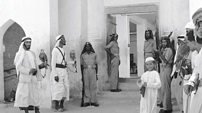 Falconers and guards inside Qasr Al Hosn, 1962. Sheikh Shakhbut would receive visitors in his majlis after the asr prayer. Guy Gravette.
