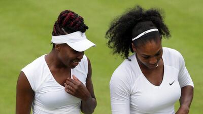Serena Williams, right, and her sister Venus of the U.S speak during a change of ends in their women's doubles match against Andreja Klepac and Katarina Srebotnik of Slovenia on day four of the Wimbledon Tennis Championships in London, Thursday, June 30, 2016. (AP Photo/Tim Ireland)