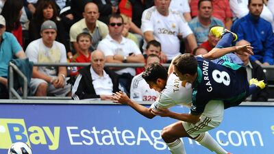 Neil Taylor of Swansea City is felled by Sunderland's Craig Gardner and left injured during their Premier League clash. Tom Dulat/Getty Images