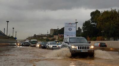 Motorists drive on a flooded street in Beirut. AP Photo